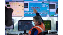 Veolia employee monitors screens in a project control center.